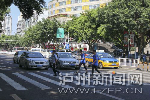 四川警察學(xué)院前的斑馬線沒有紅綠燈，但過往車輛見到有行人過斑馬線都會禮讓行人